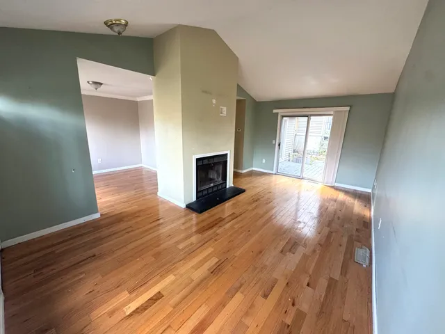 wooden floor in an empty room with a window