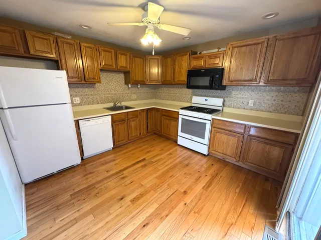 a kitchen with granite countertop stainless steel appliances and wooden cabinets
