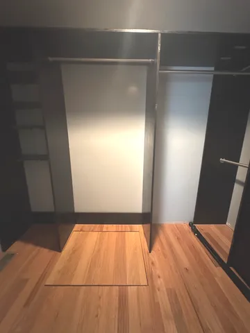 a view of a room with wooden floor