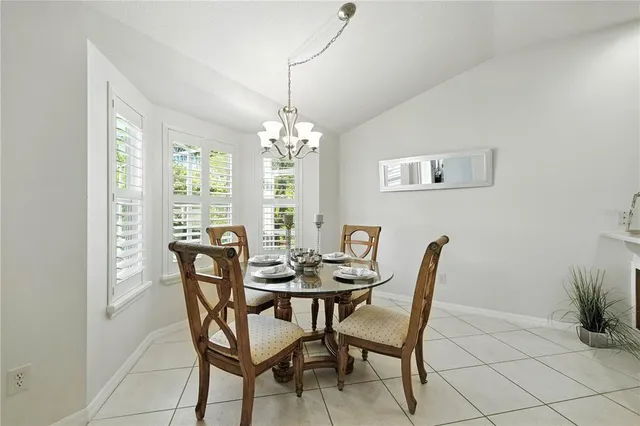 a view of a dining room with furniture and chandelier