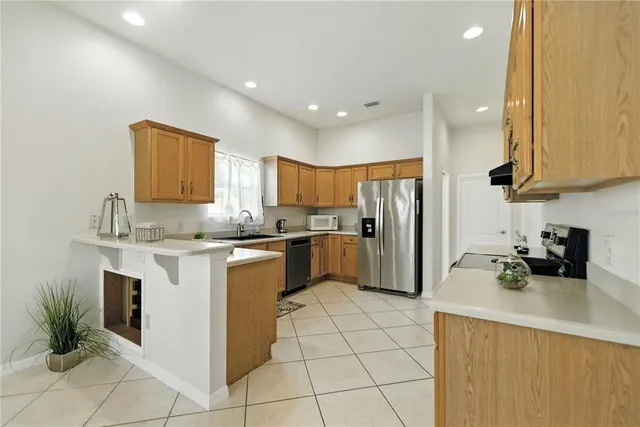a kitchen with a sink cabinets and stainless steel appliances