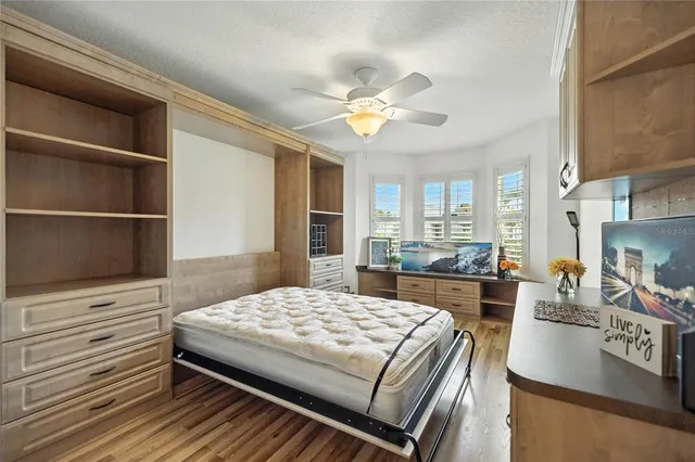 a bedroom with a bed and a view of kitchen