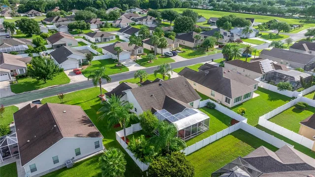 an aerial view of multiple houses with yard