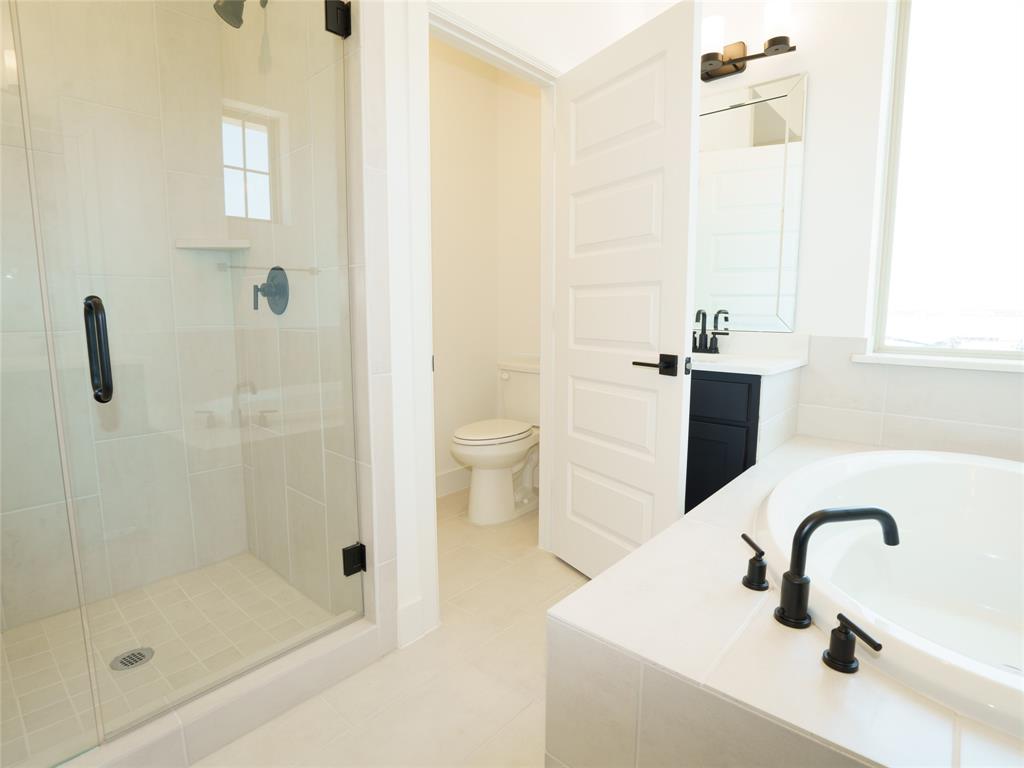 9311 Easy Street Rowlett, TX 75088 - Photo 11 of 22 Full bath with a bath, vanity, a stall shower, and light tile patterned floors