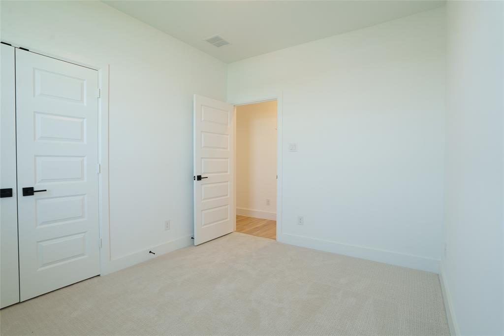 9311 Easy Street Rowlett, TX 75088 - Photo 16 of 22 Unfurnished bedroom with light carpet and baseboards