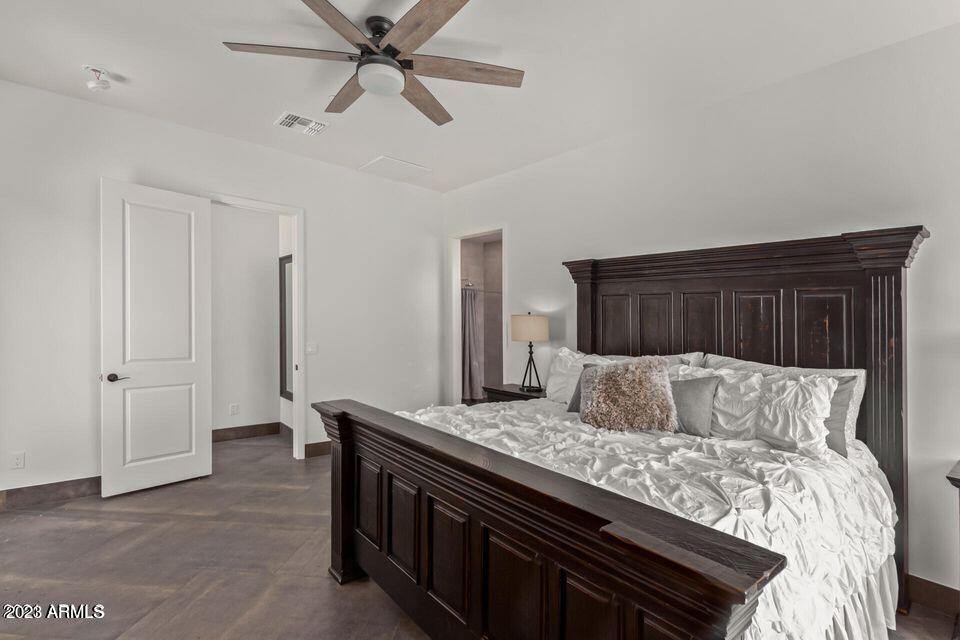 27808 Desierto Drive Rio Verde, AZ 85263 - Photo 24 of 44 a bedroom with a large bed and a ceiling fan