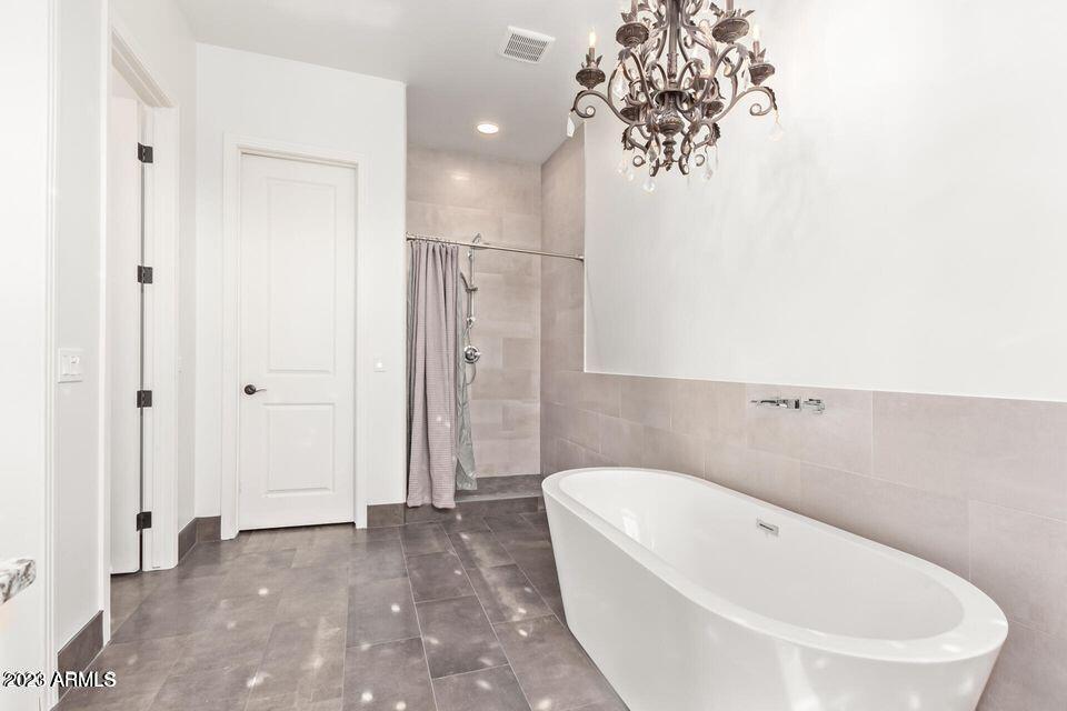 27808 Desierto Drive Rio Verde, AZ 85263 - Photo 25 of 44 a bathroom with a bathtub and a shower