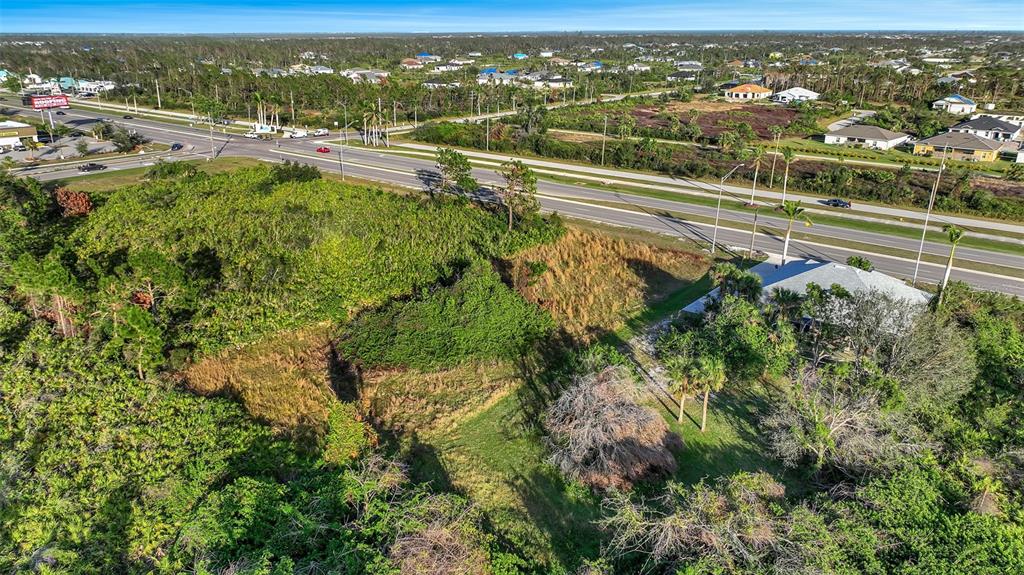 8465 Gasparilla Road Port Charlotte, FL 33981 - Photo 11 of 17 an aerial view of residential houses with outdoor space