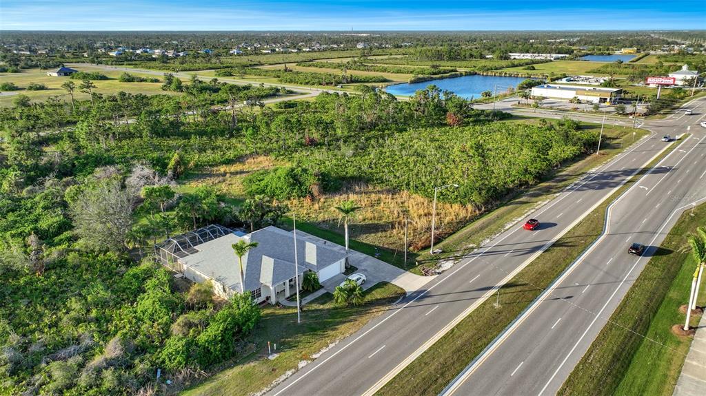 8465 Gasparilla Road Port Charlotte, FL 33981 - Photo 12 of 17 an aerial view of residential houses with outdoor space and ocean view
