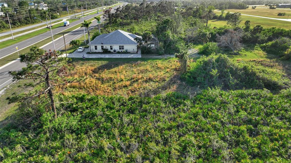 8465 Gasparilla Road Port Charlotte, FL 33981 - Photo 4 of 17 a view of a garden with a lake