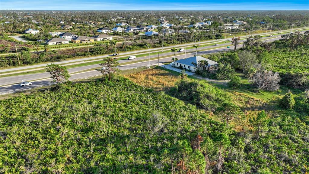 8465 Gasparilla Road Port Charlotte, FL 33981 - Photo 10 of 17 an aerial view of residential houses with outdoor space and trees