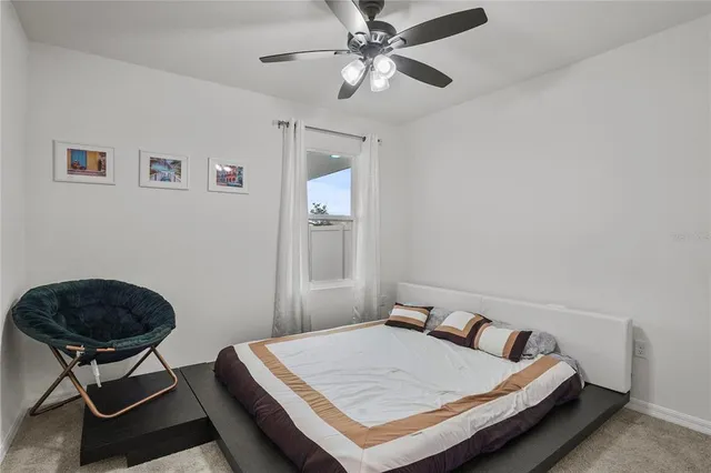 a bedroom with a bed a table and chair