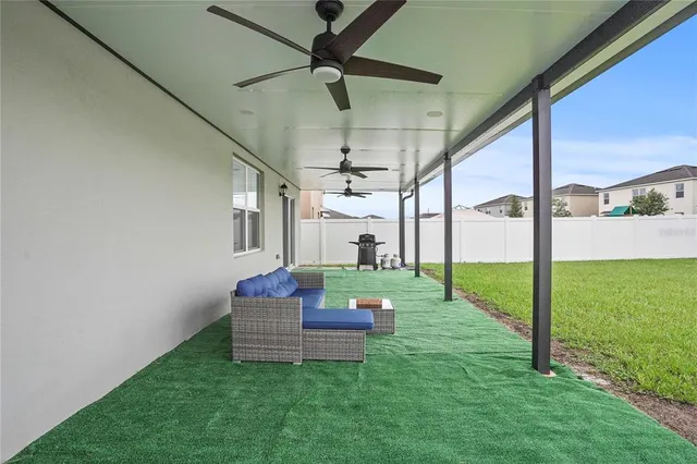 a living room with couch and a garden