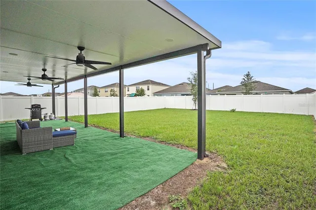 a view of a porch with furniture and a yard