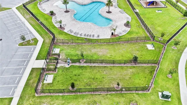 an aerial view of a residential houses with outdoor space and swimming pool