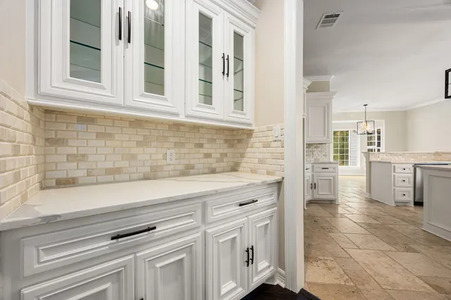 a kitchen with a sink stove and cabinets