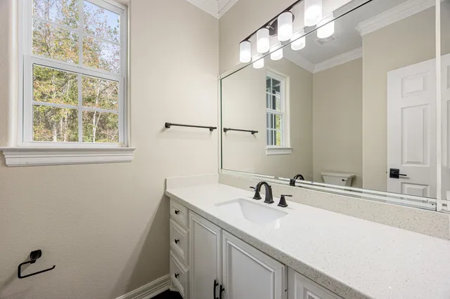 a view of a kitchen with white cabinets