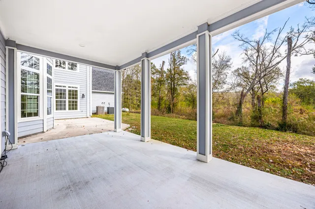 a view of a house with backyard and porch