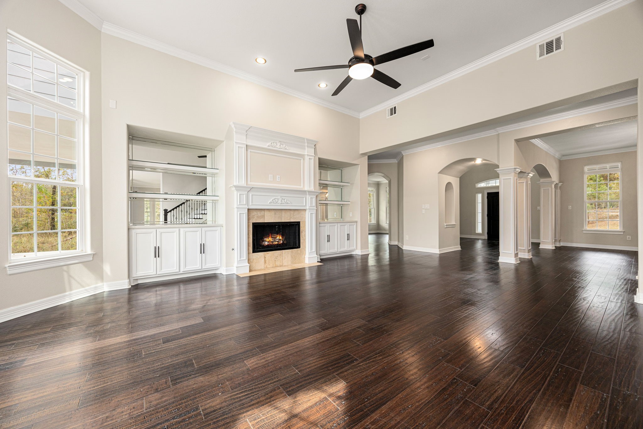 14882 Gingham Road Montgomery, TX 77356 - Photo 9 of 38 an empty room with wooden floor fireplace and windows