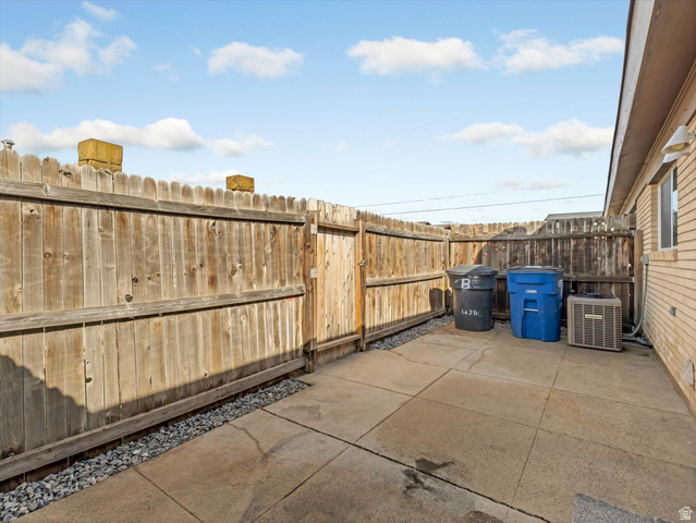 1478 North 75 West, Unit AD Sunset, UT 84015 - Photo 15 of 26 Fenced backyard with a patio area