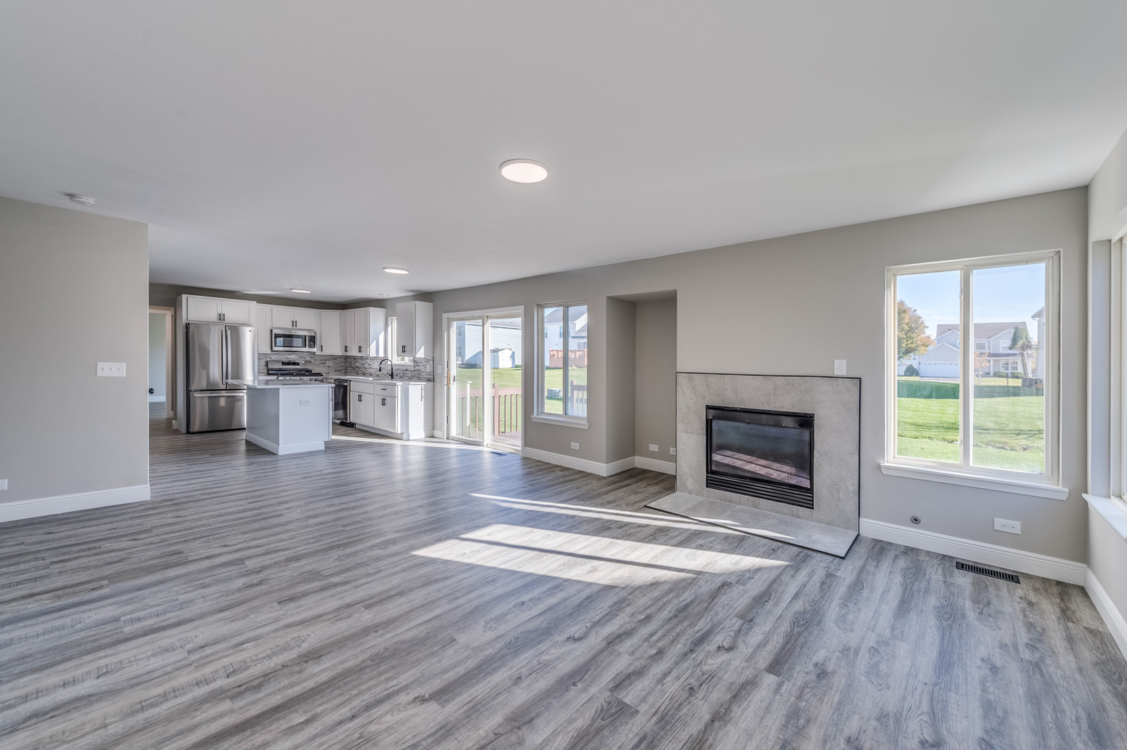 153 Treehouse Road Matteson, IL 60443 - Photo 8 of 19 a view of empty room with wooden floor and fireplace