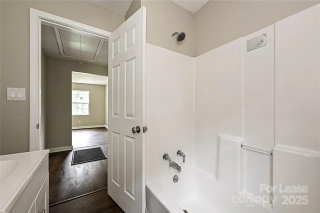 a bathroom with a bathtub and shower