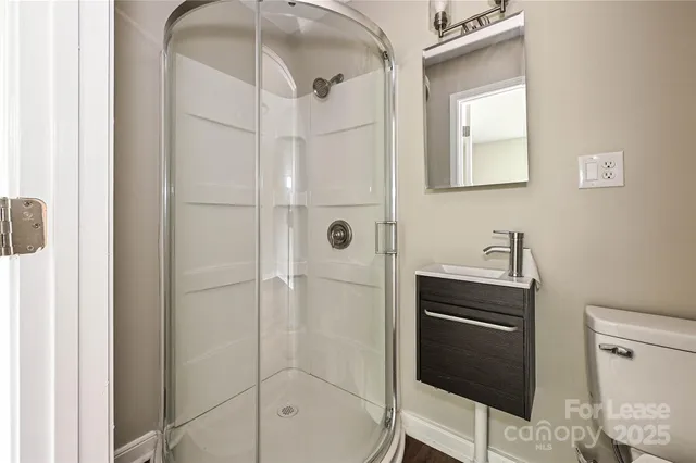 a bathroom with a shower and a sink