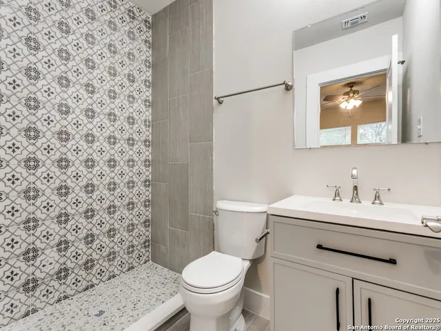 a bathroom with a sink toilet and a mirror