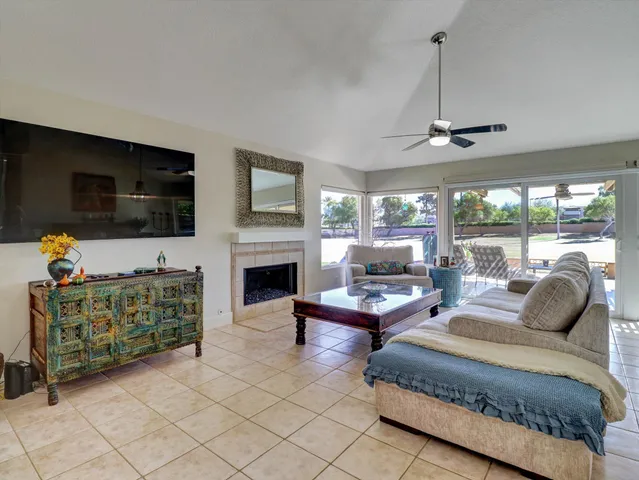 a living room with furniture fireplace and flat screen tv