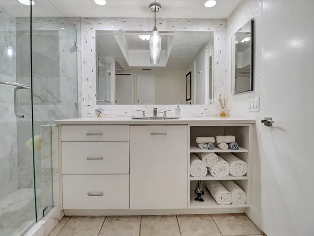 a spacious bedroom with a bed and a television