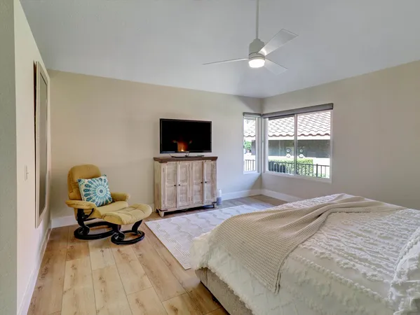 a spacious bedroom with a bed and a chandelier