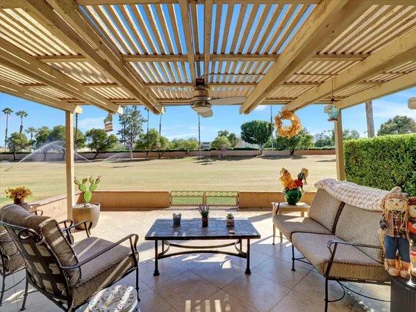 a view of a patio with swimming pool and sitting space
