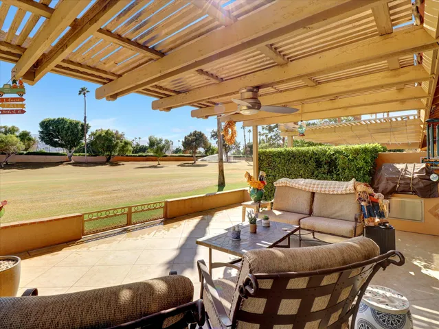 a view of a building with sitting area and furniture