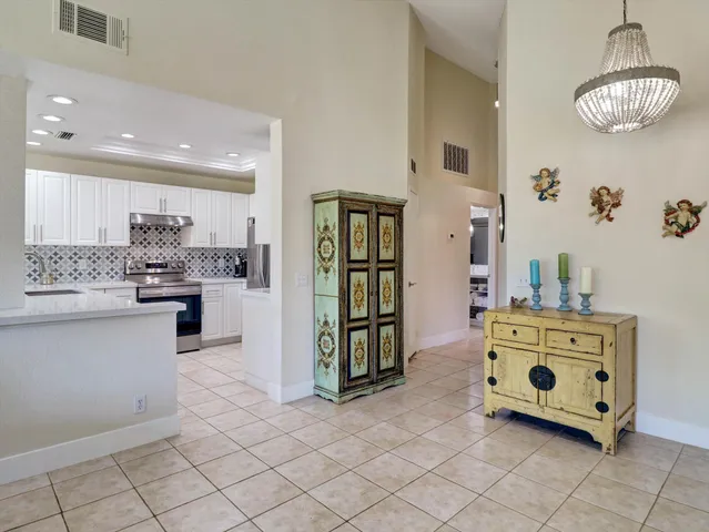 a kitchen with stainless steel appliances kitchen island granite countertop a stove and cabinets