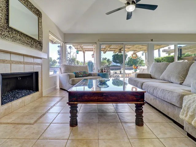 a living room with furniture a window and a fireplace