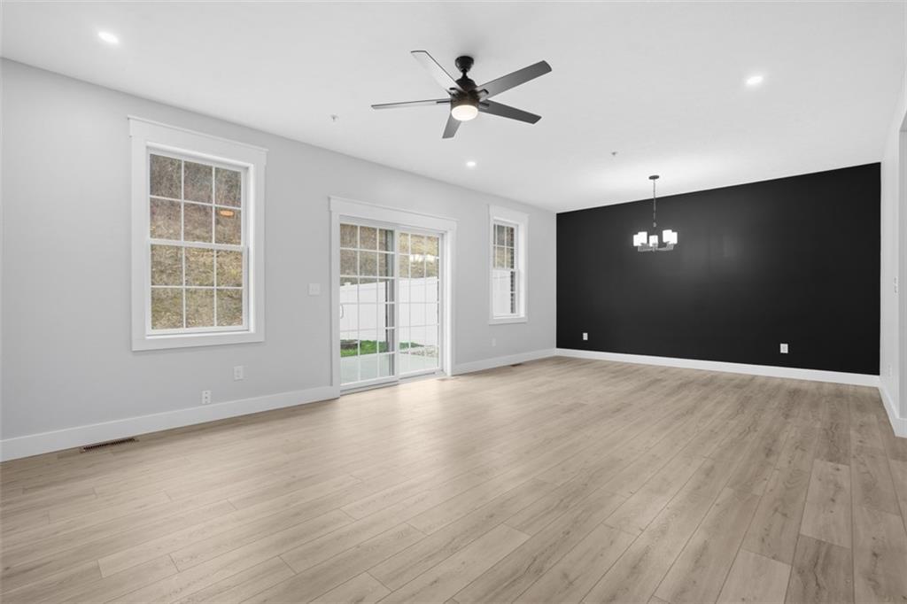 2339 Old Greentree Road Carnegie, PA 15106 - Photo 15 of 48 a view of an empty room with wooden floor and a window