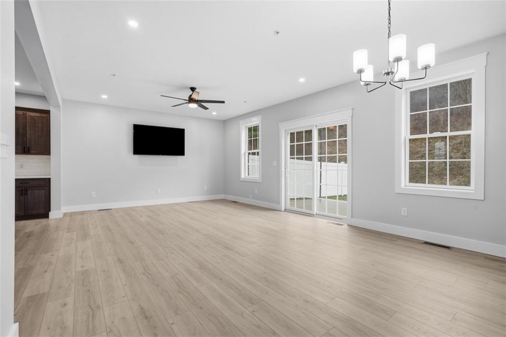2339 Old Greentree Road Carnegie, PA 15106 - Photo 21 of 48 a view of an empty room with a window and wooden floor