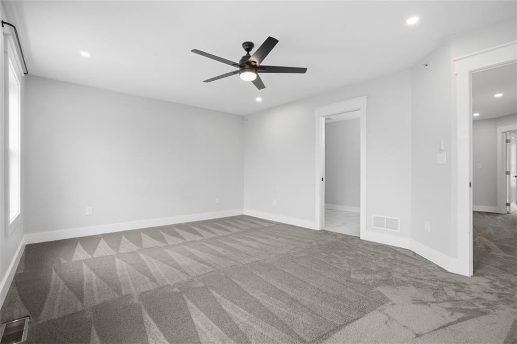 2339 Old Greentree Road Carnegie, PA 15106 - Photo 31 of 48 an empty room with wooden floor and a ceiling fan