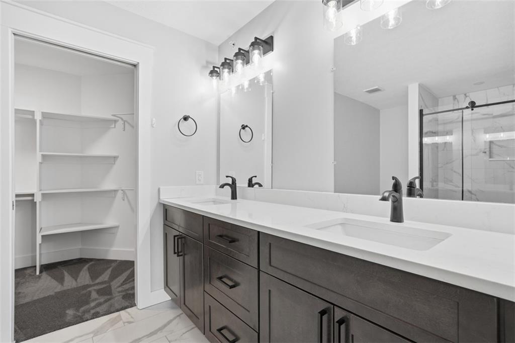 2339 Old Greentree Road Carnegie, PA 15106 - Photo 33 of 48 a bathroom with a double vanity sink a mirror and a shower