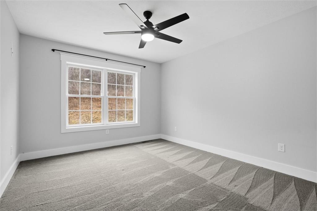 2339 Old Greentree Road Carnegie, PA 15106 - Photo 37 of 48 an empty room with a window and a fan