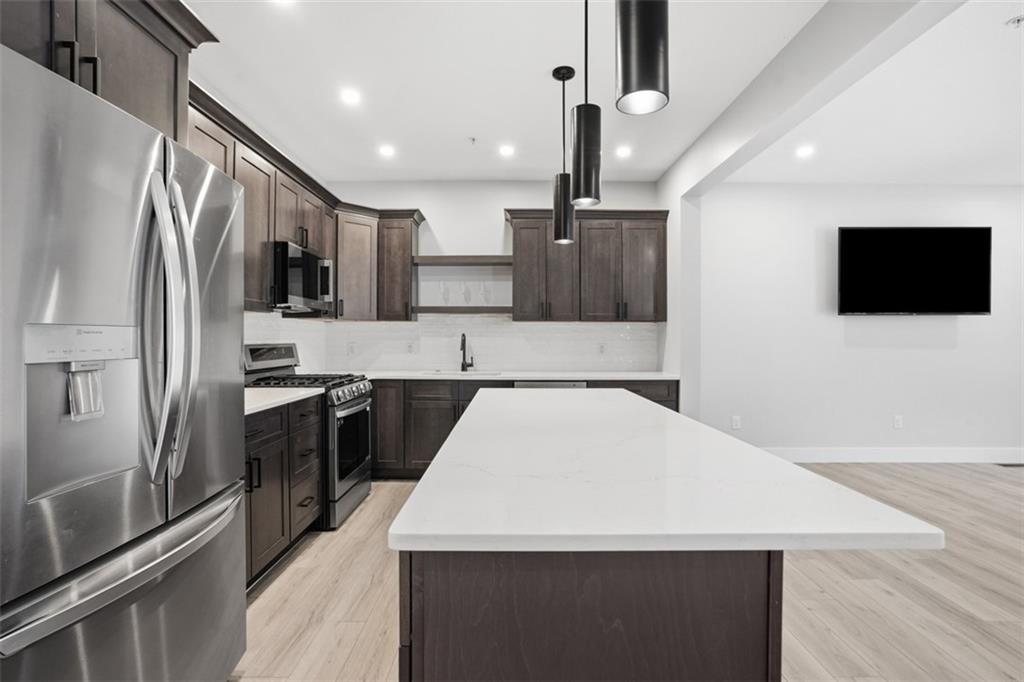 2339 Old Greentree Road Carnegie, PA 15106 - Photo 10 of 48 a large kitchen with kitchen island a sink stainless steel appliances and cabinets