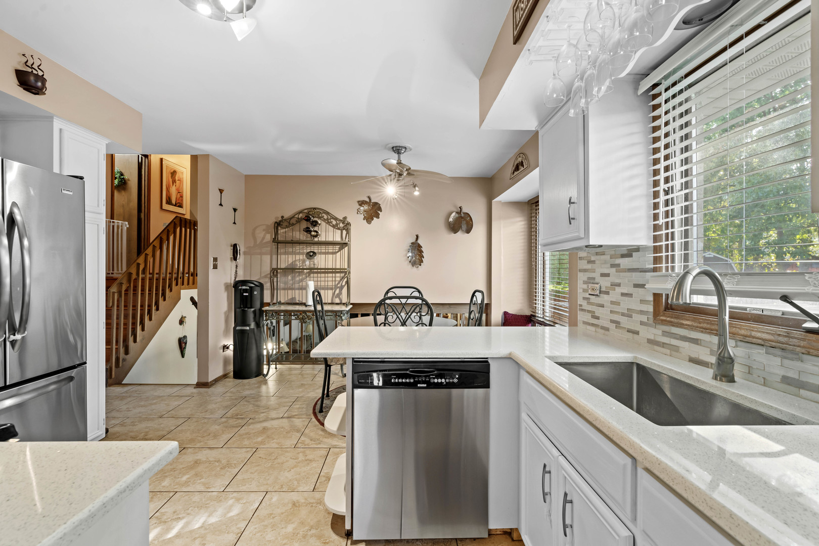 3686 Ronald Road Crete, IL 60417 - Photo 11 of 35 a kitchen with stainless steel appliances granite countertop a refrigerator a sink and white cabinets