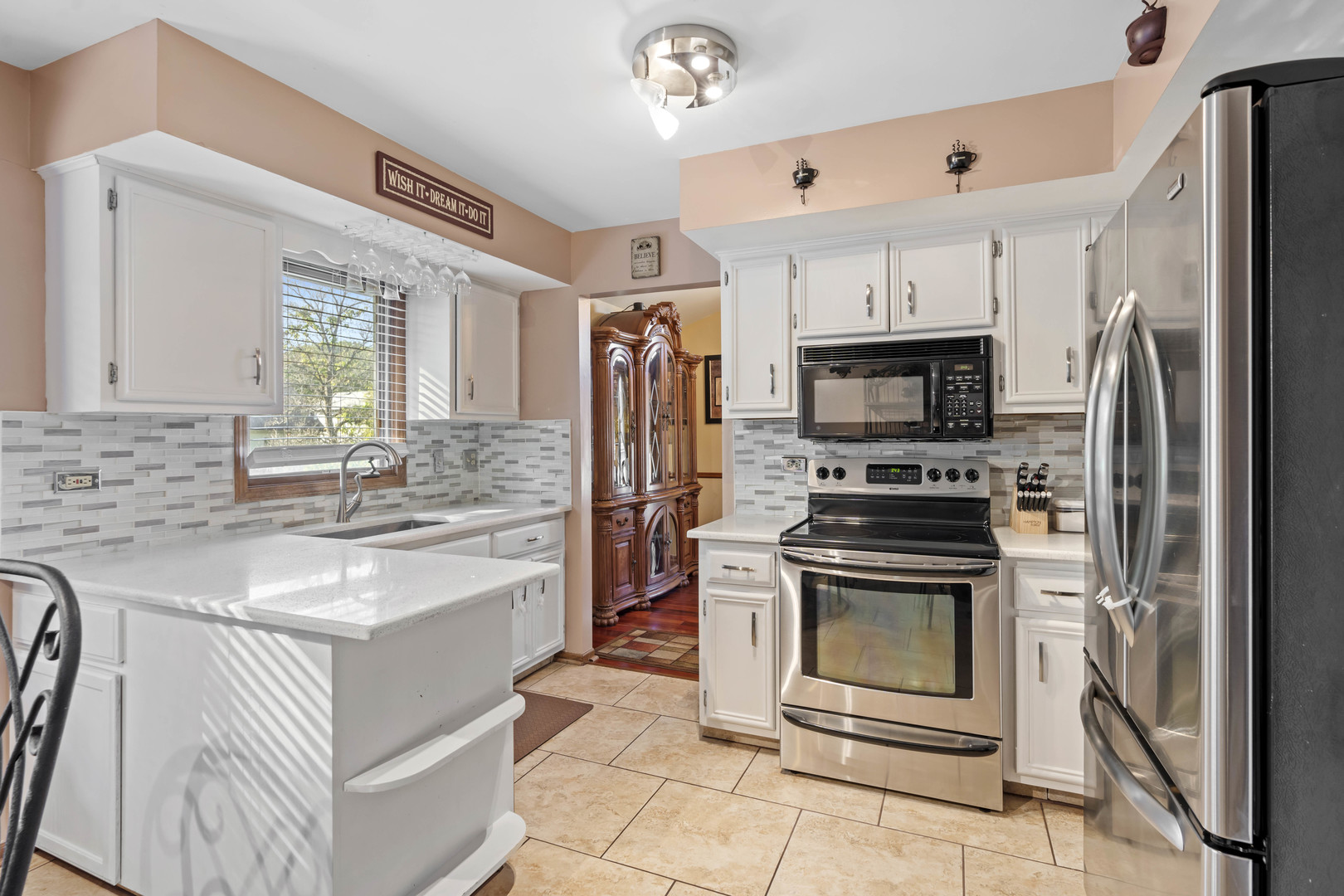 3686 Ronald Road Crete, IL 60417 - Photo 13 of 35 a kitchen with kitchen island granite countertop a stove sink and microwave