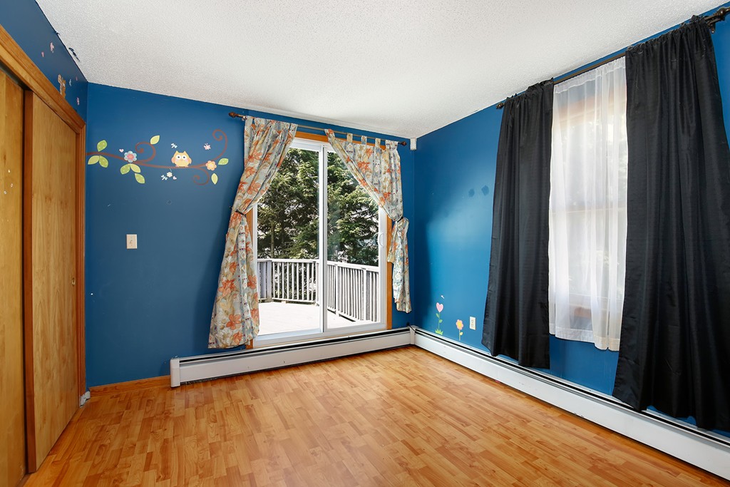 3 Jennifer Road Lowell, MA 01854 - Photo 16 of 25 a view of an empty room with a fireplace and a large window