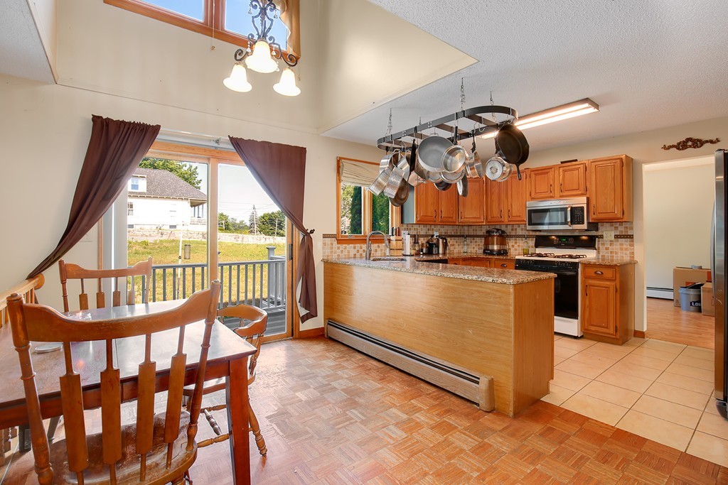 3 Jennifer Road Lowell, MA 01854 - Photo 3 of 25 a view of a kitchen with furniture and a window