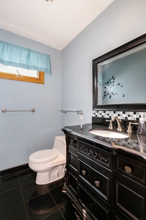 3 Jennifer Road Lowell, MA 01854 - Photo 9 of 25 a bathroom with a toilet a sink and mirror