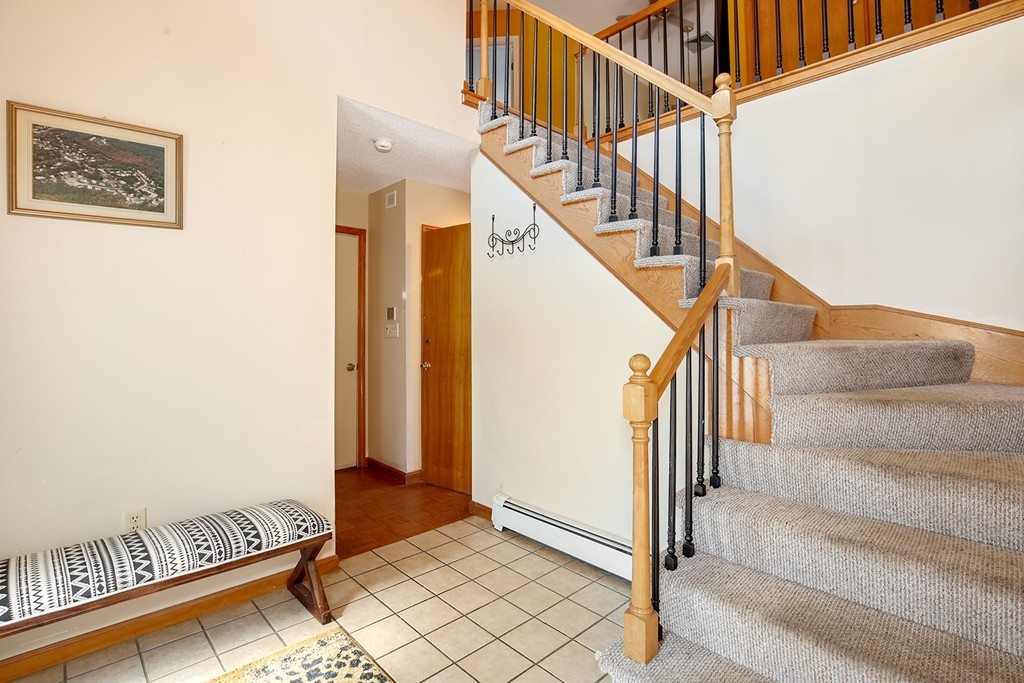 3 Jennifer Road Lowell, MA 01854 - Photo 10 of 25 a view of staircase with lots of frames and a rug