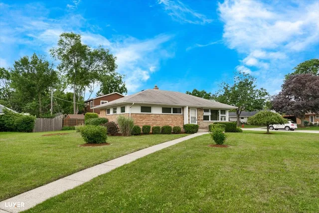 a view of an house with backyard space and garden