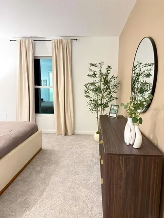 a bedroom with a large bed and a couch