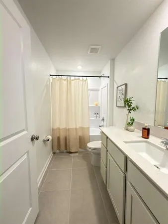 a bedroom with a bed and a lamp